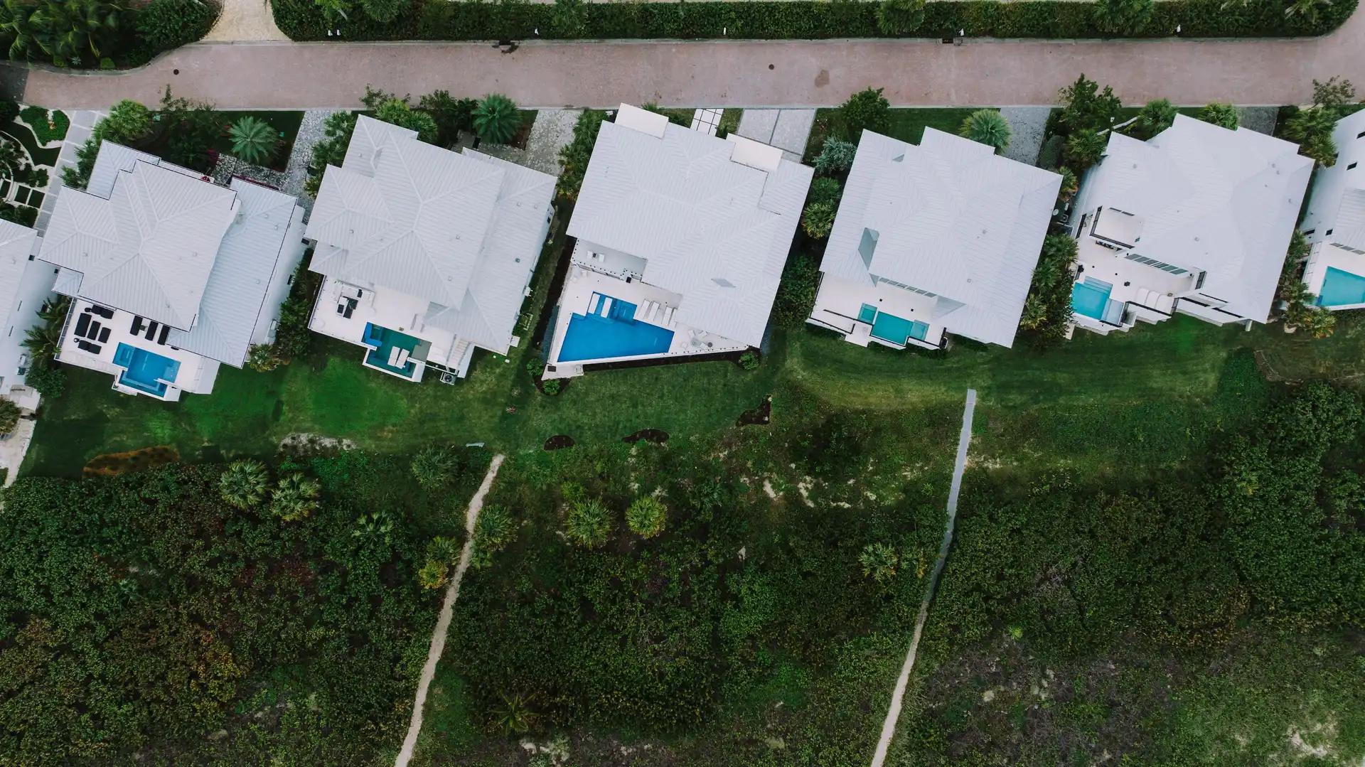 Aerial view of homes with pools in a Florida neighborhood