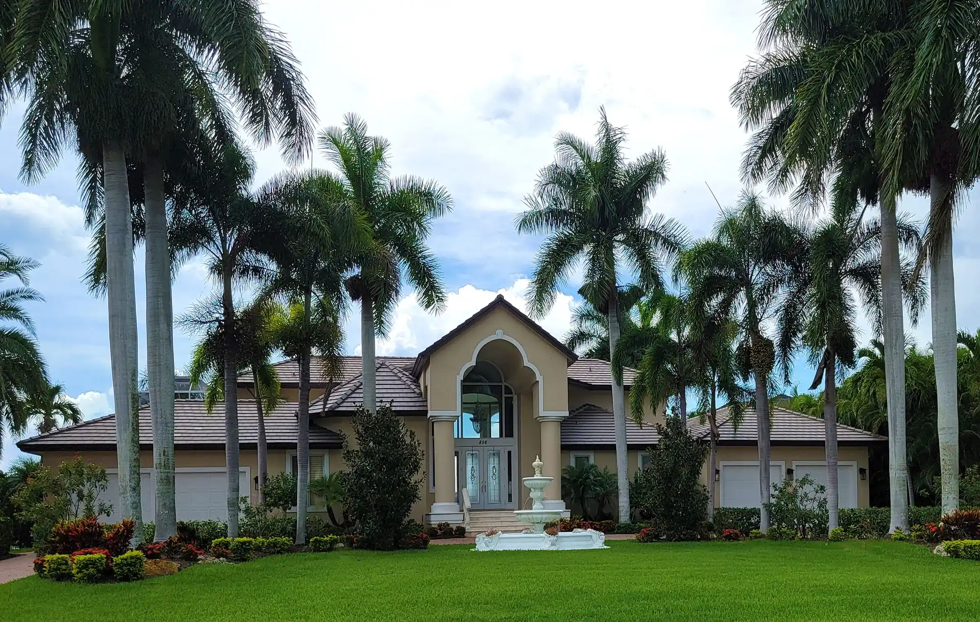 Large Florida home surrounded by palm trees