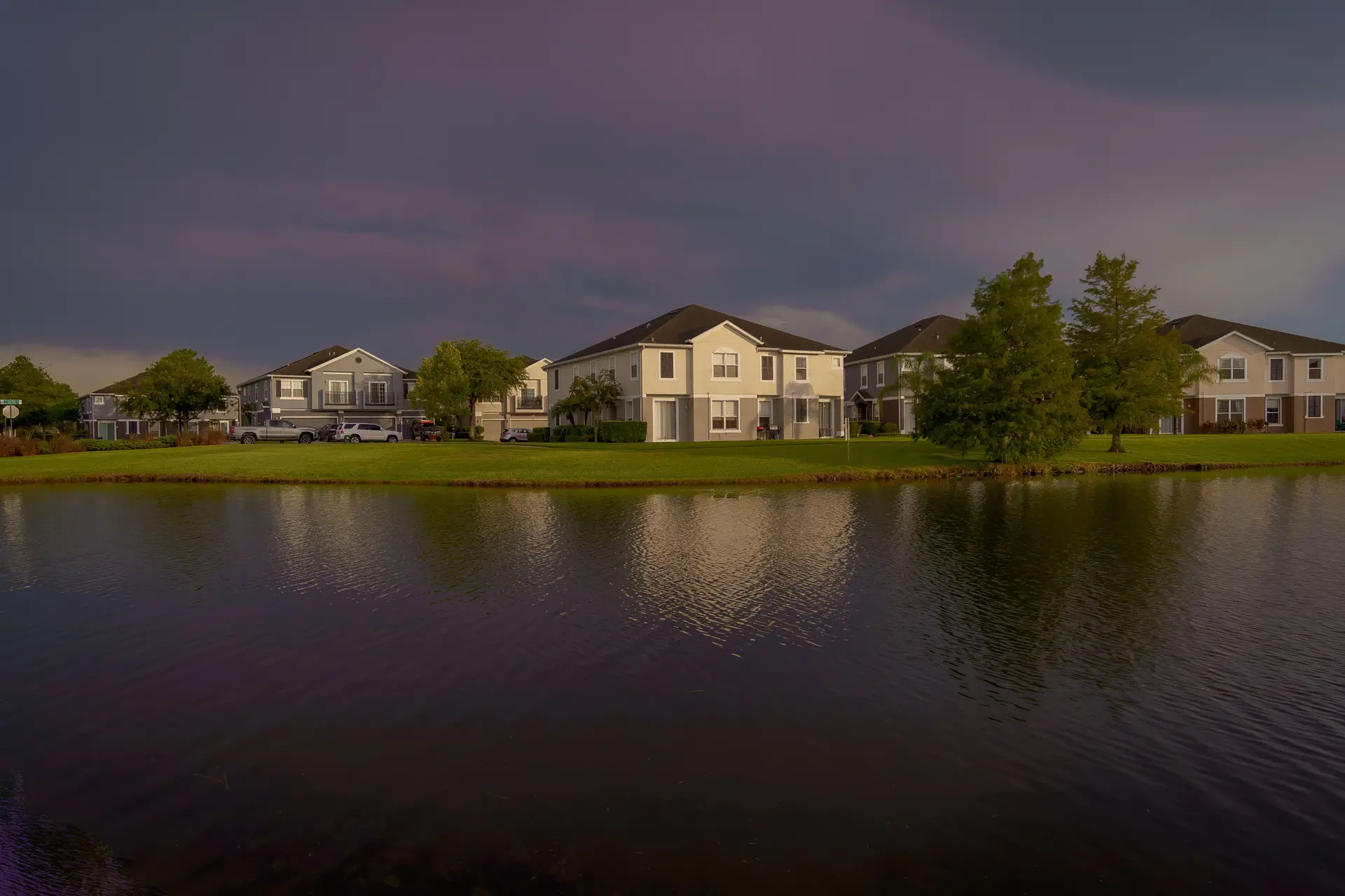Lakefront homes under an evening sky
