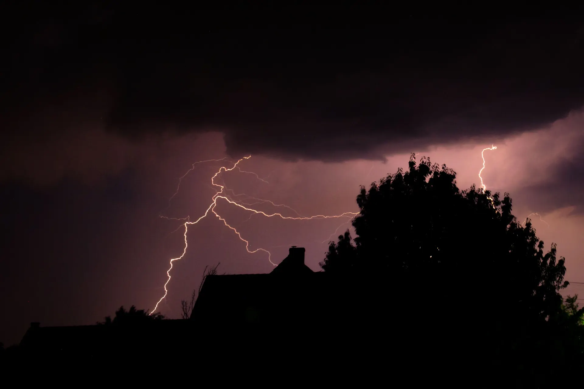 Lightning over a home at night