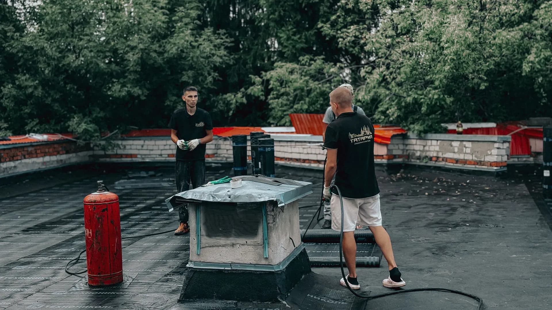 Workers on a flat commercial roof