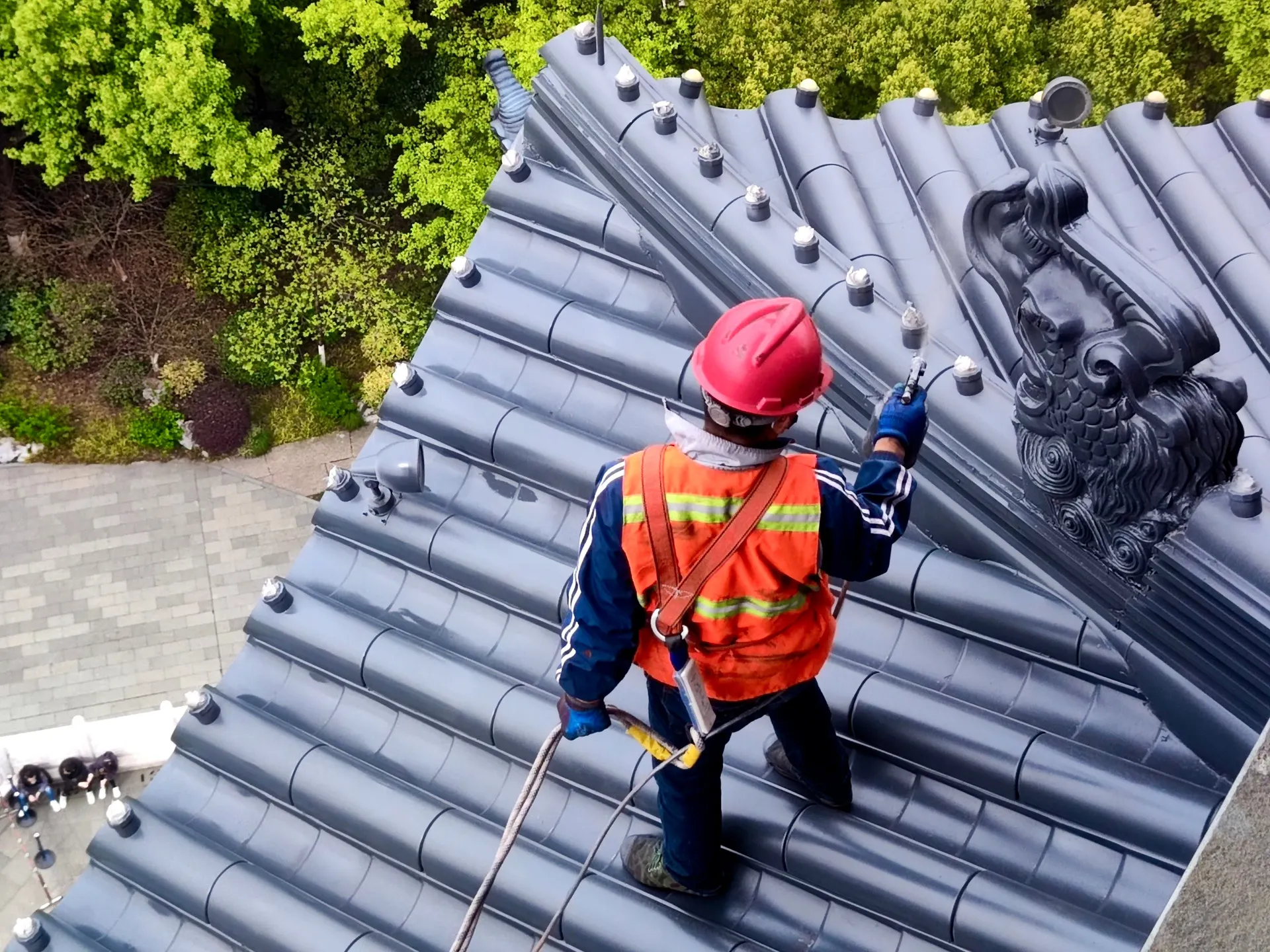 Roof inspector in a hard hat checking a metal roof