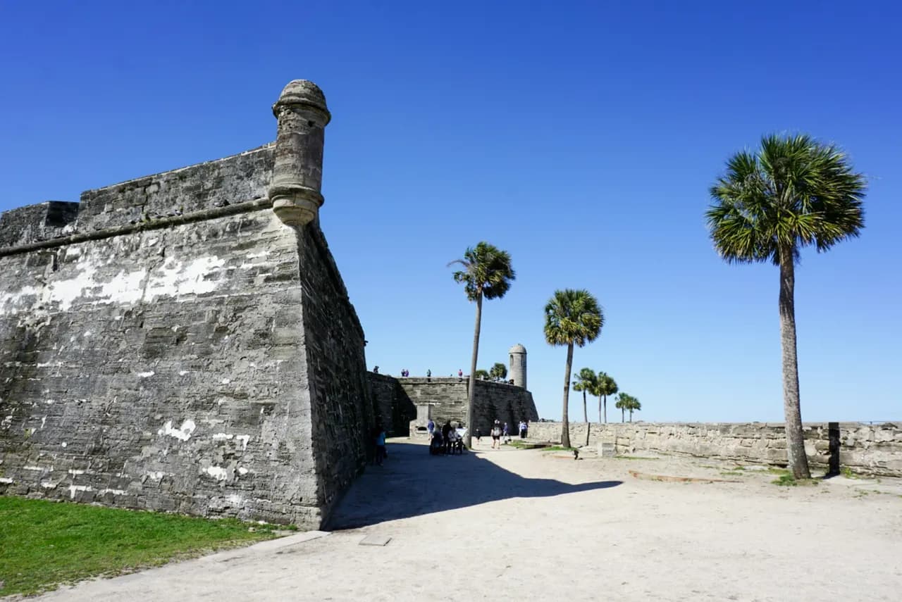 Coquina walls of the Castillo de San Marcos with palm trees